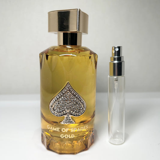 Game Of Spades Gold parfum spray bottle by Jo Milano Paris, unisex amber spicy fragrance with orange, brandy, and warm amber notes, and 8 mL travel-size decant sprayer, unisex amber spicy parfum