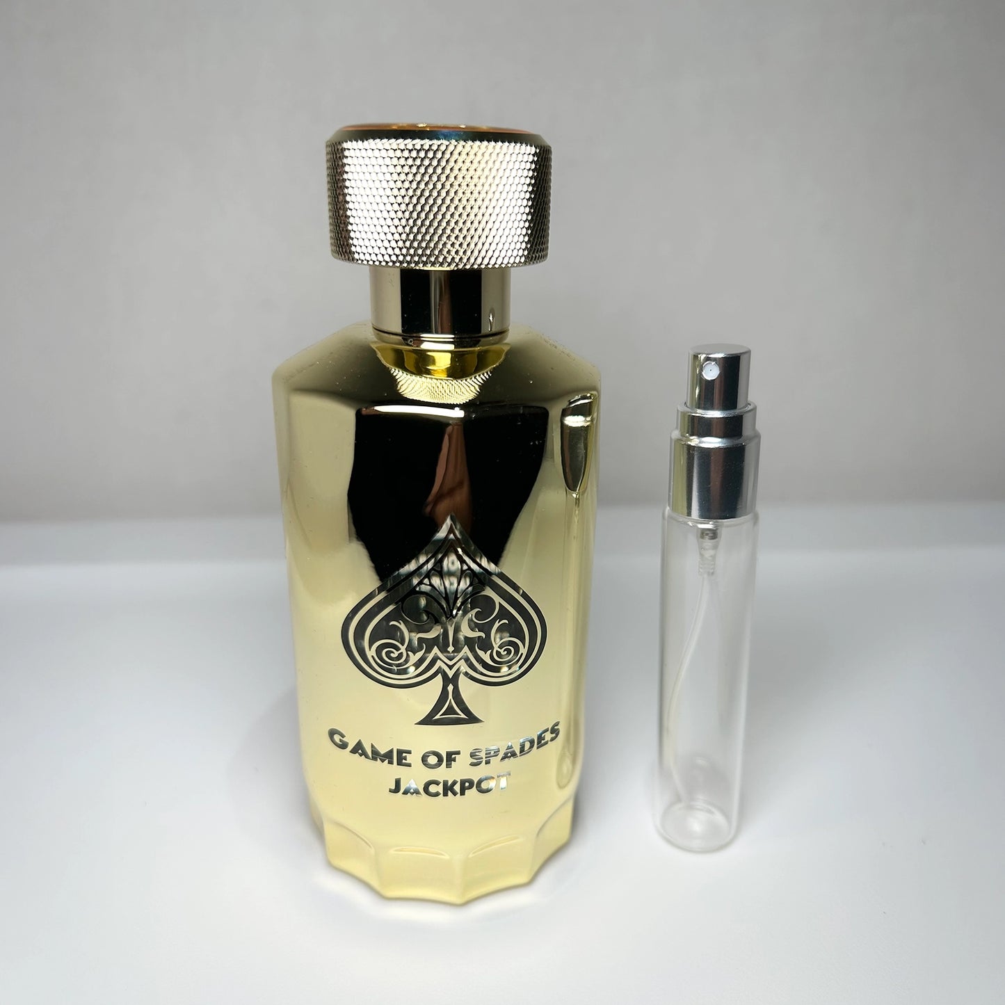 Game of Spades Jackpot parfum bottle with 8 mL travel-size decant sprayer by Jo Milano Paris, unisex luxury fragrance